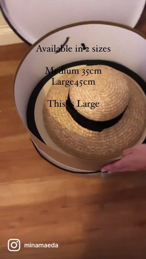 Round hat box made of cardboard, covered with